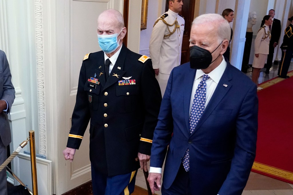 President Biden initially wore a mask to a ceremony where he gave the Medal of Honor to Vietnam War veteran Capt. Larry Taylor — before taking it off.