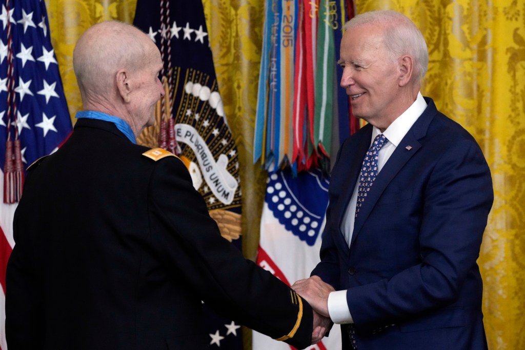 Biden shaking the 81-year-old veteran's hand at the ceremony.