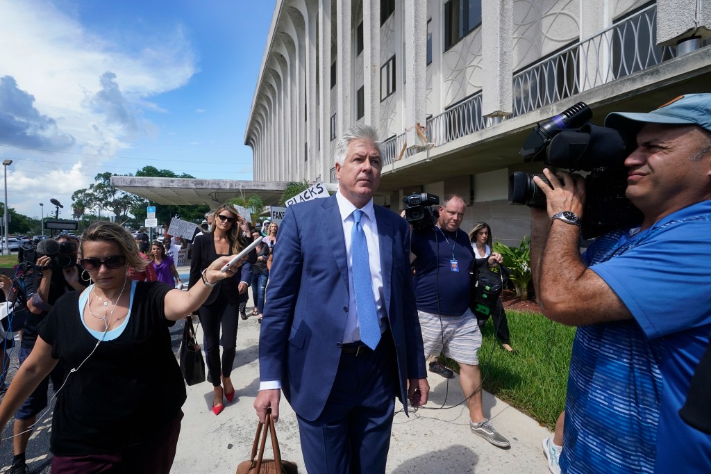 Attorney Evan Corcoran, center, leaves the Paul G. Rogers Federal Building and U.S. Courthouse in West Palm Beach, Fla., Thursday, Sept. 1, 2022.