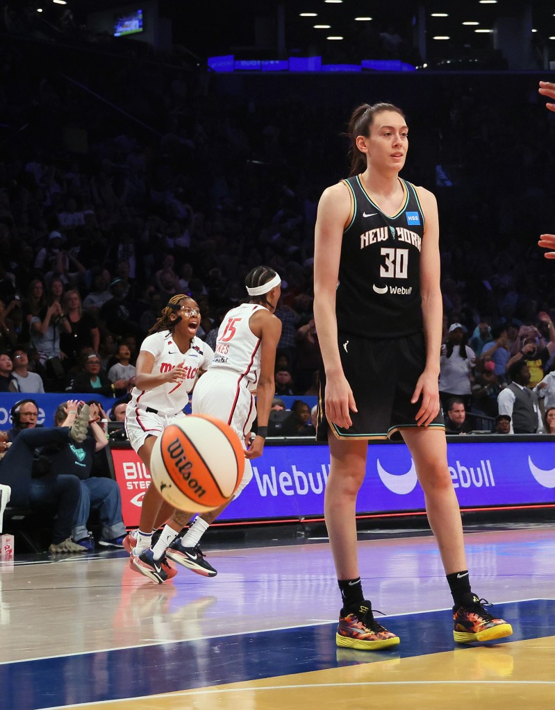 Brittney Sykes (15) and the Washington Mystics celebrate her game winning basket against the New York Liberty on Sept. 10, 2023.