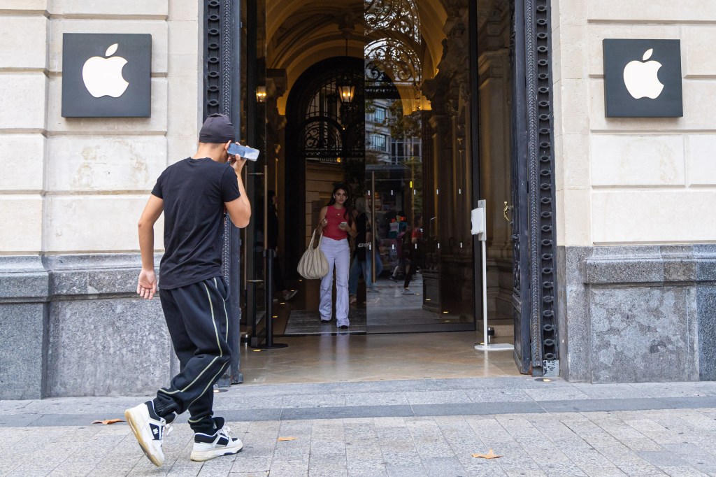 Customers enter the Apple Store in Paris.