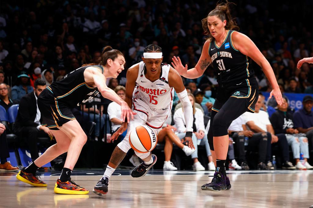 Brittney Sykes (15) of the Washington Mystics attempts to move past the New York Liberty players on Sept. 10, 2023.