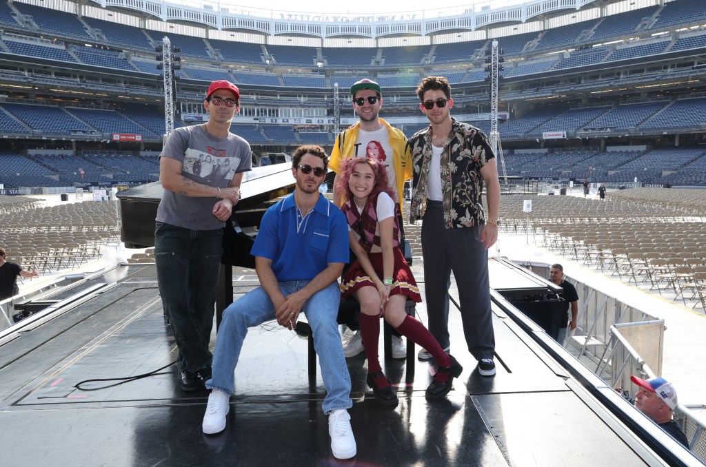 Grace and Clyde Lawrence with the Jonas Brothers at Yankee Stadium.