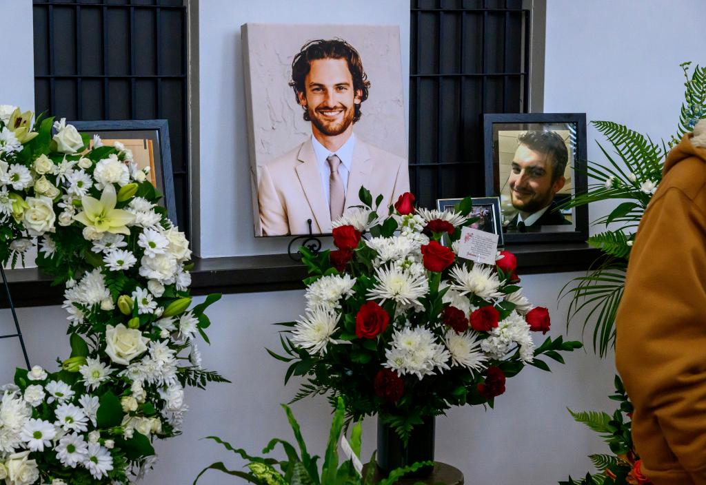 Photos of Adam Johnson line the ticket window booth at the Hibbing Memorial Building, in Hibbing, Minn., Monday, Nov. 6, 2023, as part of a celebration of life ceremony for the hockey player.