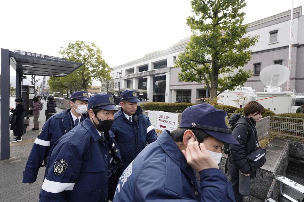 Police officers gather outside the Kyoto District Court in Kyoto, western Japan, Thursday, Jan. 25, 2024, ahead of the sentencing hearing for Shinji Aoba