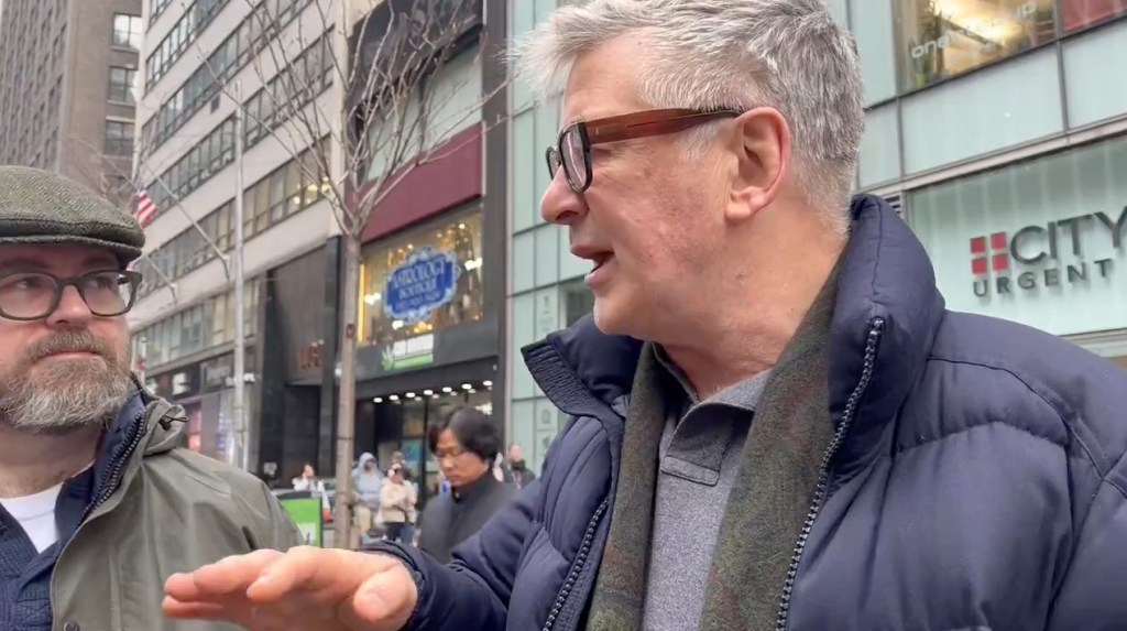 Alec Baldwin standing in the street. 