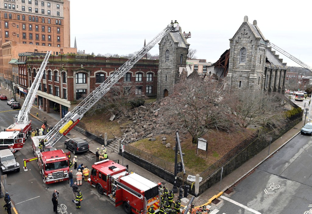 Collapsed church building with emergency vehicles outside in New London, Connecticut.