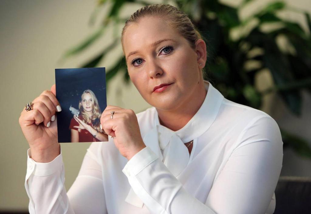 Virginia Giuffre holds a photo of herself as a teen, when she says she was abused by Jeffrey Epstein, Ghislaine Maxwell and Prince Andrew, among others