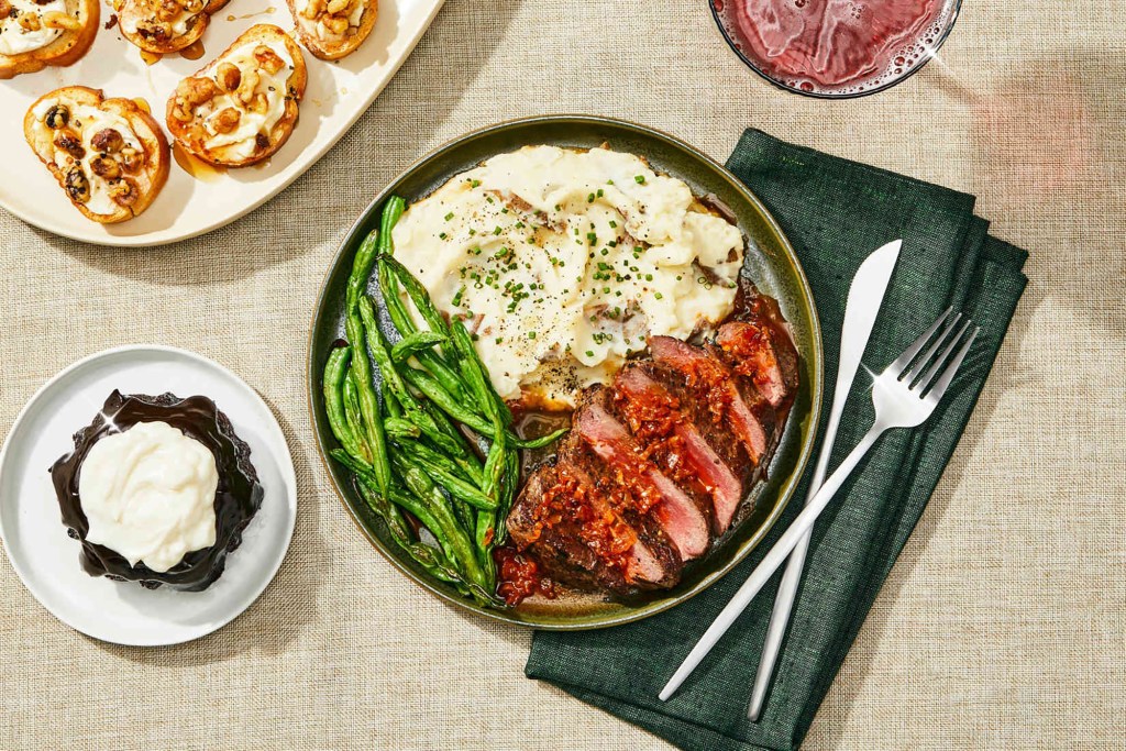 steak, potatoes, and greens on a plate