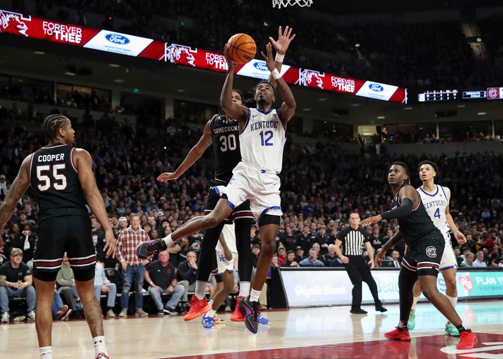 Kentucky guard Antonio Reeves (12) scores inside over South Carolina forward Collin Murray-Boyles (30) during the second half of an NCAA college basketball game Tuesday, Jan. 23, 2024, in Columbia, S.C. South Carolina won 79-62. 