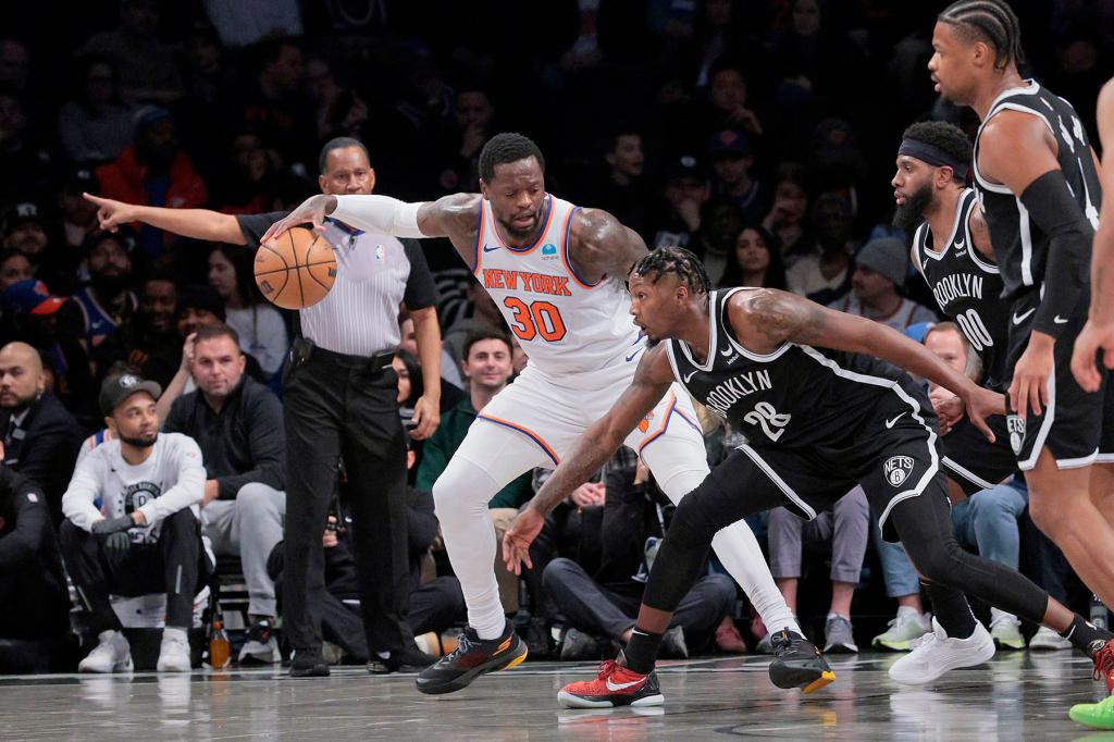 Dorian Finney-Smith #28 of the Brooklyn Nets tries to steal the ball from Julius Randle #30 of the New York Knicks during the first period