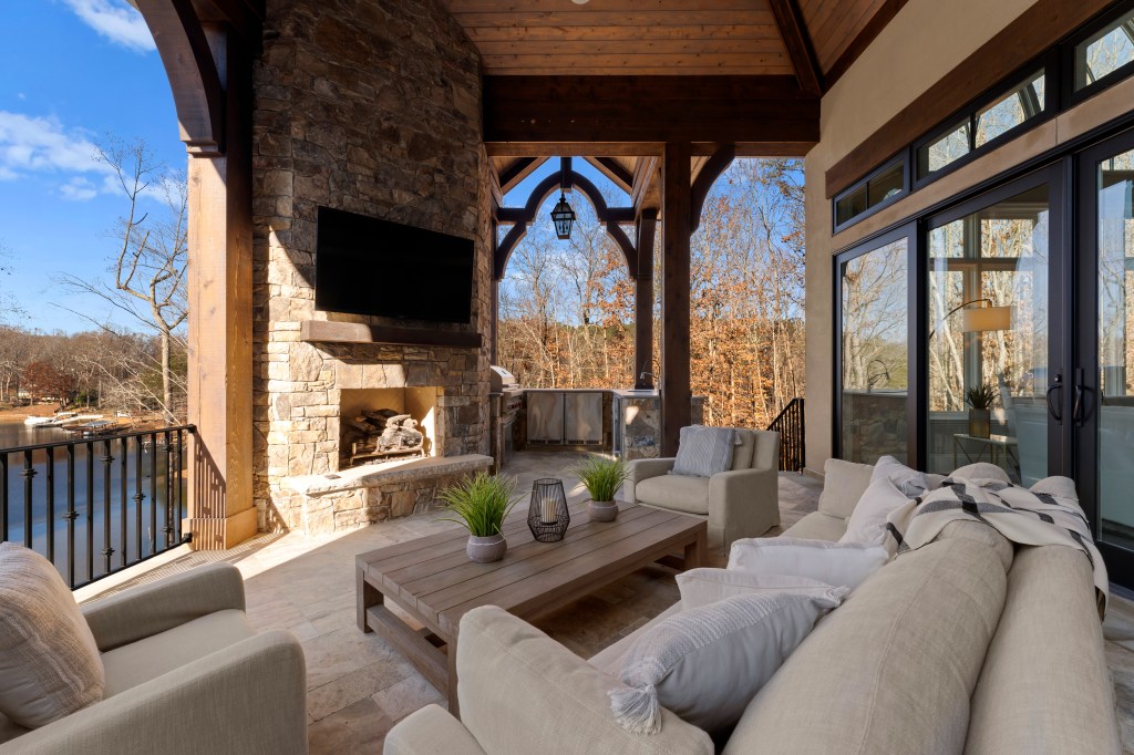 The outdoor loggia with a television and fire place.