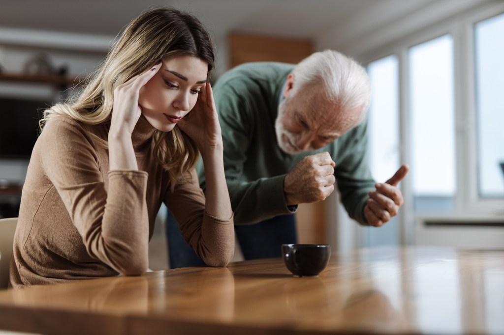 Woman looking stressed next to older man