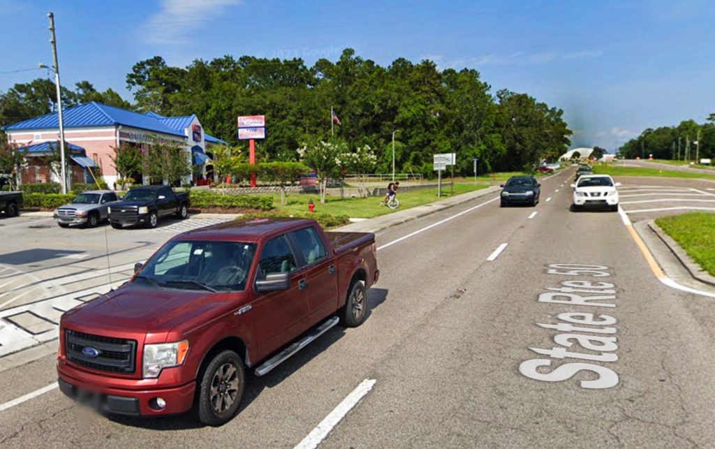 Cars drive on State Road 50 in Brooksville, Florida