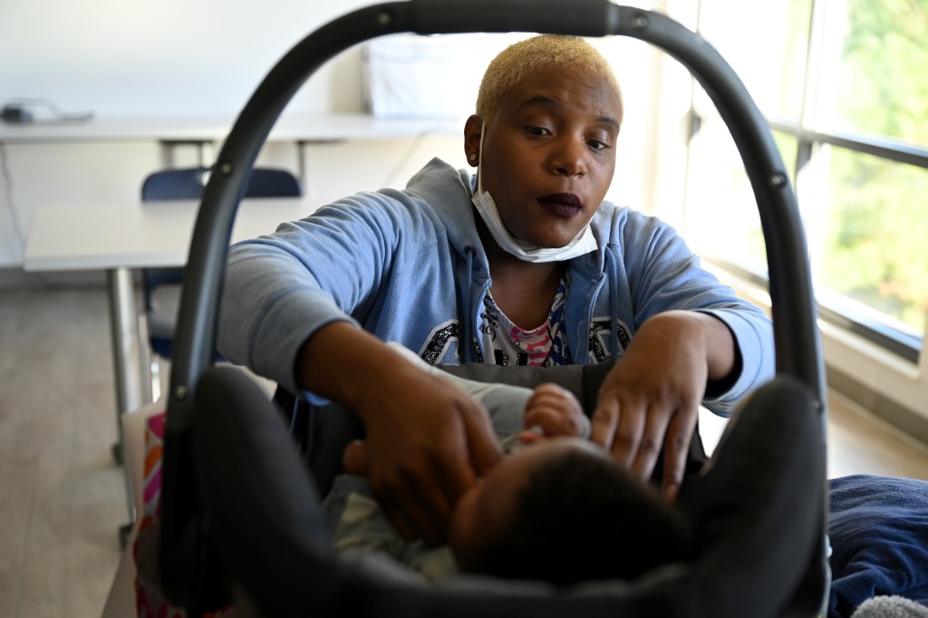 Canethia Miller attends to her youngest son at Martha's Table on Sept. 27, 2022.