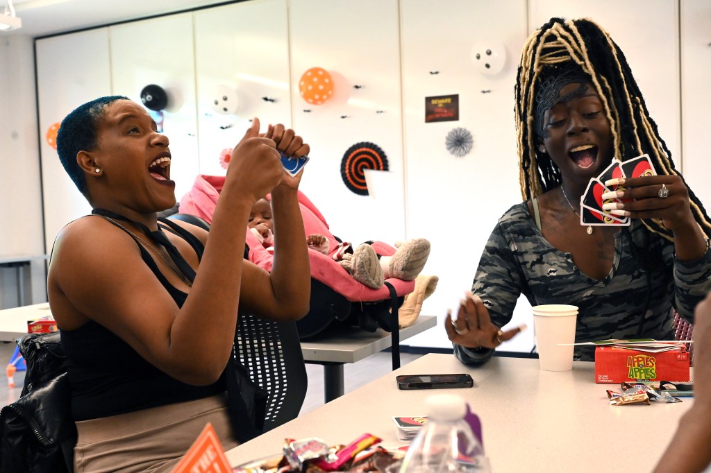 Canethia Miller, left, plays Uno at Martha's Table during a meet and greet for the Strong Families Strong Futures participants on Oct. 27, 2022 in Washington, DC.