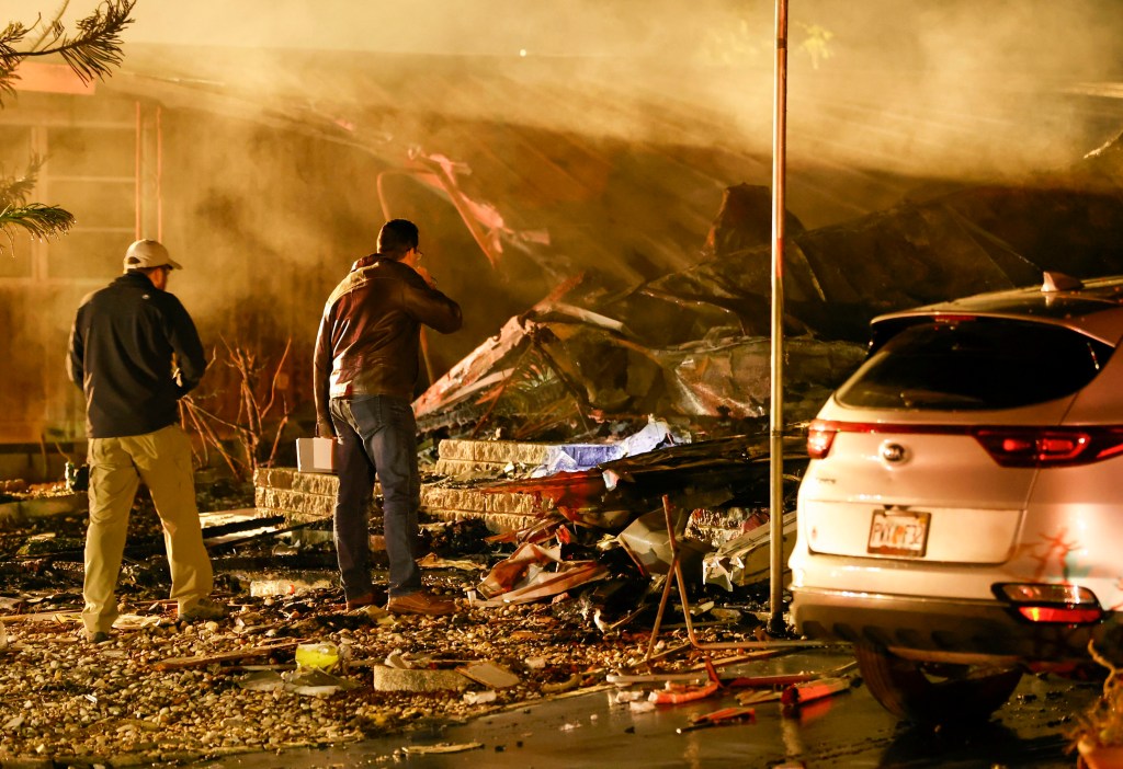 Investigators look at the burned out remains of a mobile home after a plane crash Thursday, Feb. 1, 2024 in Clearwater, Fla. Fire officials say a small plane has crashed into a home at a Florida mobile home park, killing several people aboard the plane and in the home. (Chris Urso/Tampa Bay Times via AP)