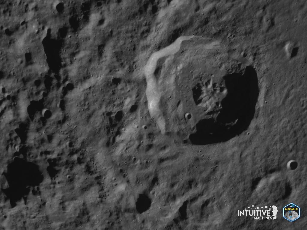 A moon crater seen by Odysseus' camera as the lunar lander prepares for landing.