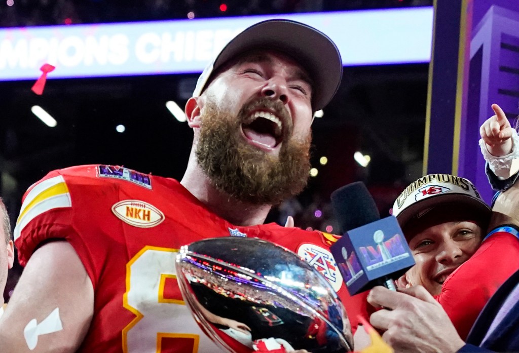 Kansas City Chiefs' tight end #87 Travis Kelce holds the trophy