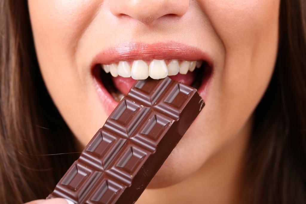 a woman eating chocolate bar