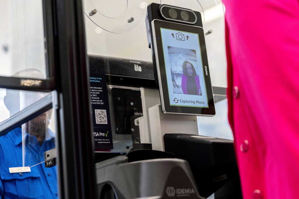 A person poses for a photo while demonstrating the Transportation Security Administration's new facial recognition technology.