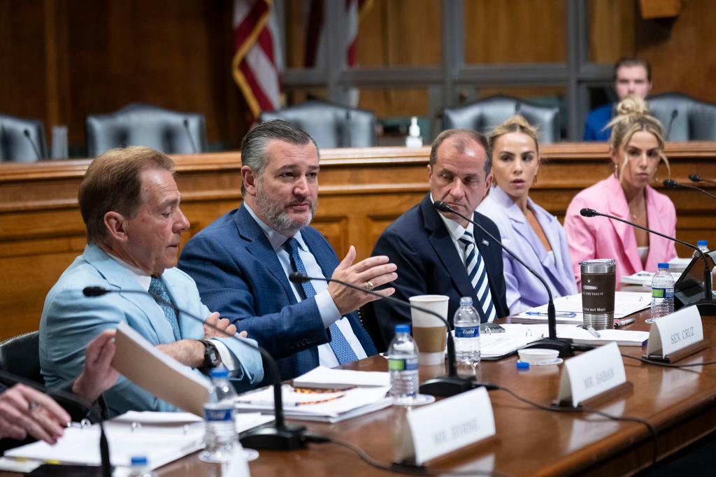 Sen. Ted Cruz, Nick Saban, Jim Phillips, Hanna Cavinder and Haley Cavinder seated at a table on Capitol Hill.