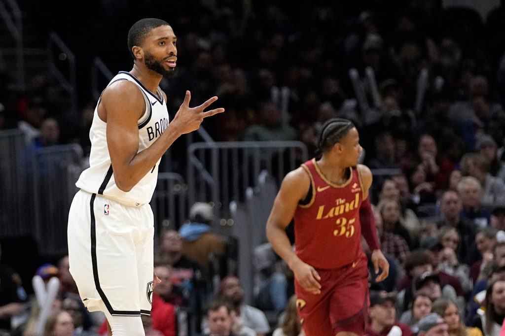  Mikal Bridges, left, gestures after hitting a three-point basket over Cleveland Cavaliers forward Isaac Okoro.