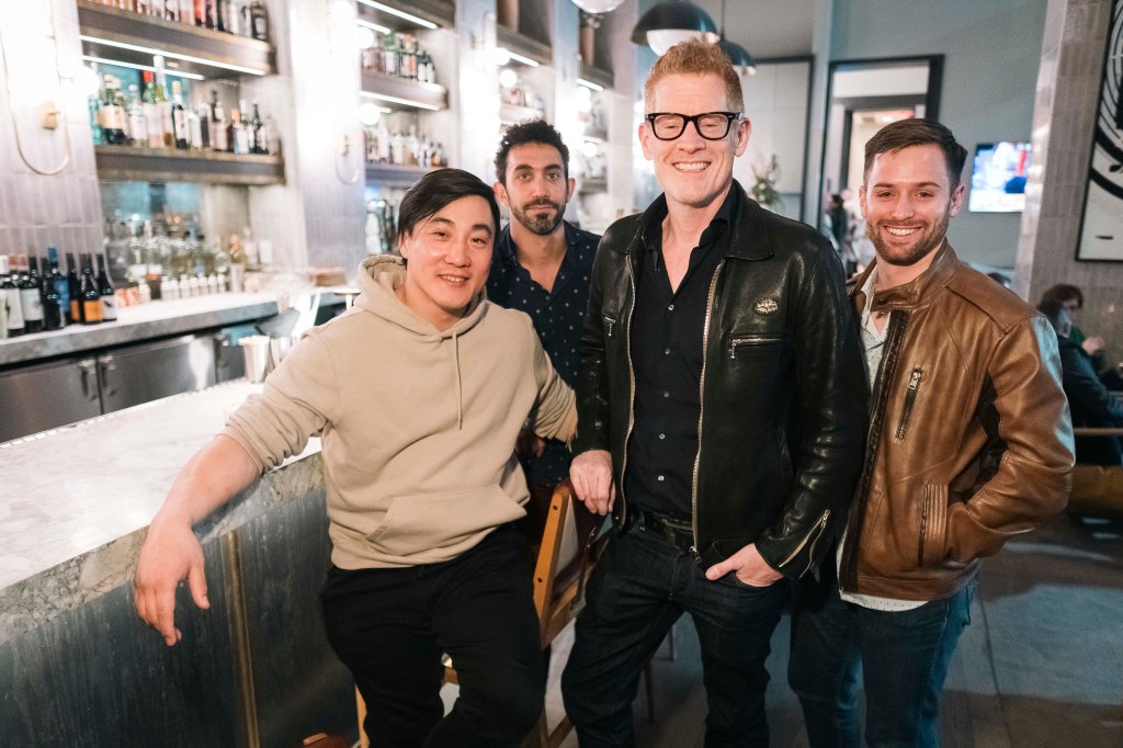 Connell Barrett (center) with clients at a bar in midtown. 