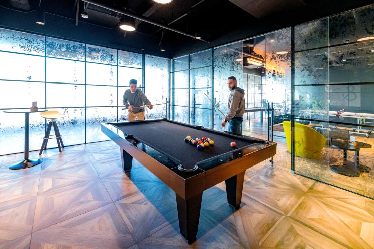 Two men play pool at One World Trade Center.