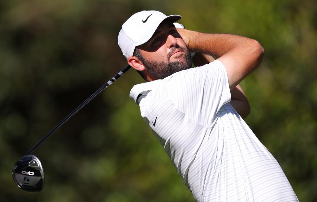 Scottie Scheffler hits a tee shot on the 11th hole during the third round of the Masters.