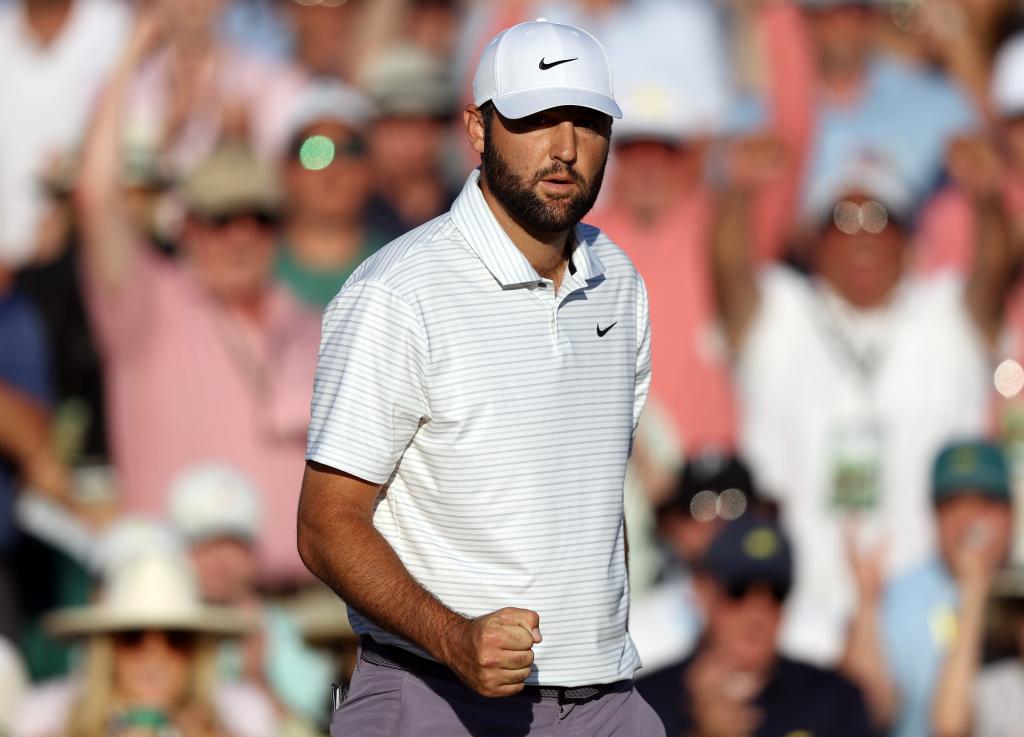 Scottie Scheffler pumps his fist after making a birdie on the 18th hole during the third round of the Masters.