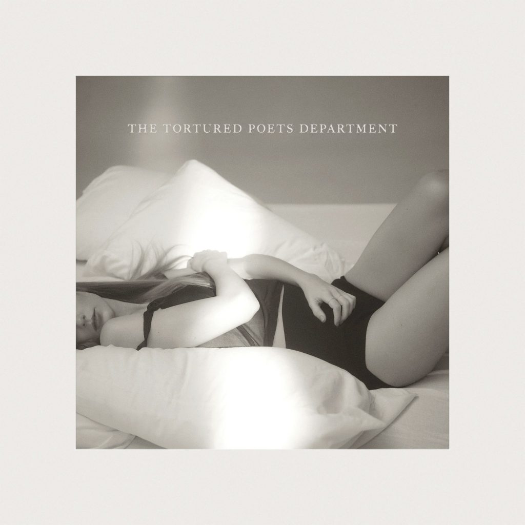 Taylor Swift lying on a bed, cover image for her new album 'The Tortured Poets Department' released by Republic Records