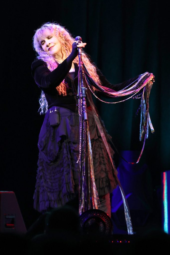 Stevie Nicks, holding a microphone, performing at Madison Square Garden in New York City, October 2023