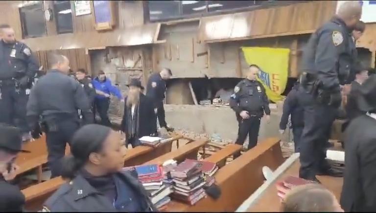 A riot broke out at a Brooklyn synagogue Monday when cops tried to hold back a group of Orthodox Jewish men who were pushing their way into an illegal tunnel they built.