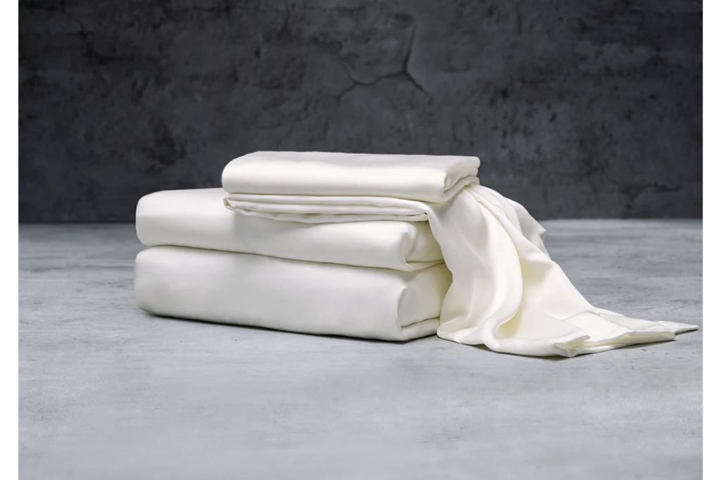 A stack of white sheets against a dark backdrop.