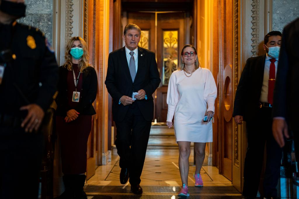 Sen. Joe Manchin (D-WV) leaves the Senate Chamber with Sen. Kyrsten Sinema (D-AZ) following a vote in the Senate at the U.S. Capitol Building on Wednesday, Nov. 3, 2021 in Washington, DC.