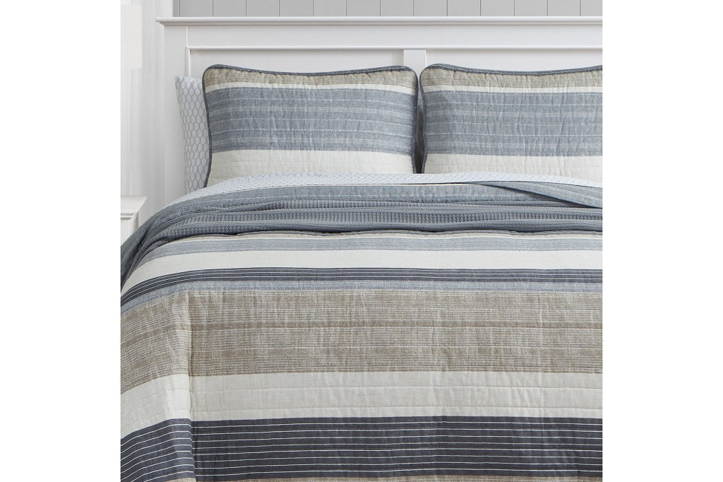 A bed with striped bedding