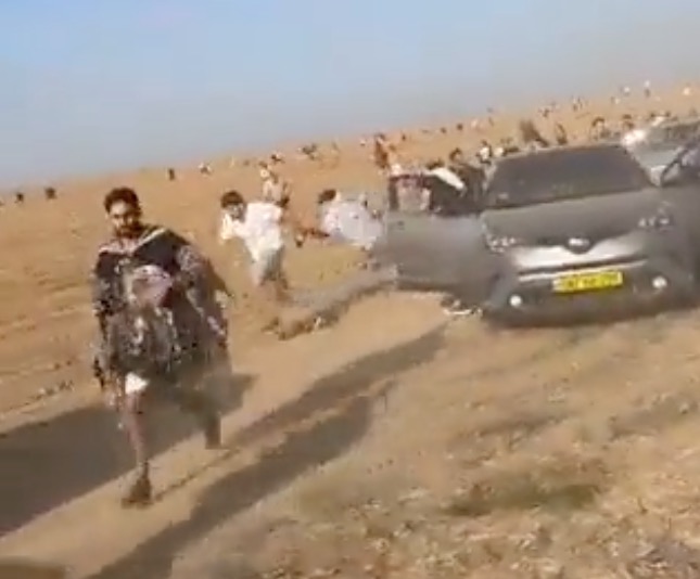 Twitter video grabs show attendees at the Tribe of Nova music festival running from a terrorist attack during a Hamas incursion Saturday, Oct. 7, 2023, in Southern Israel