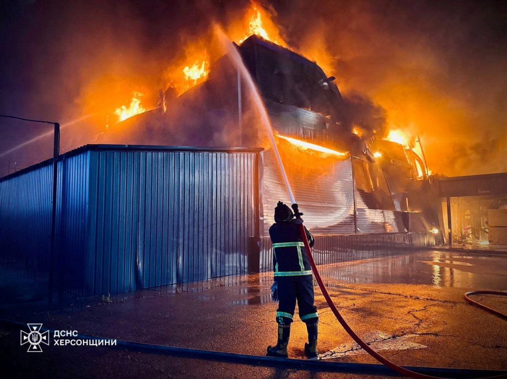 A firefighter works at a site of a household items shopping mall hit by a Russian military strike.