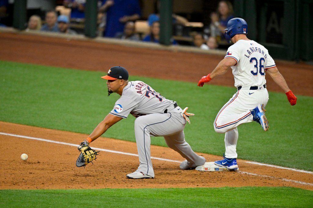 Texas Rangers designated hitter Wyatt Langford (36) beats out the throw to Houston Astros first base Jose Abreu (79) during the second inning at Globe Life Field. 