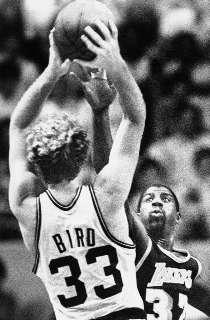 Larry Bird of the Boston Celtics shooting over Magic Johnson of the Los Angeles Lakers during the 1984 NBA playoff game