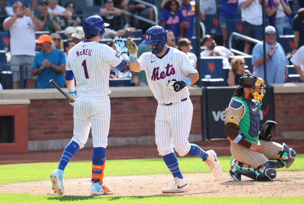 Mets catcher Luis Torrens is congratulated after hitting a home run in the eighth inning on Sunday against the Padres at Citi Field.