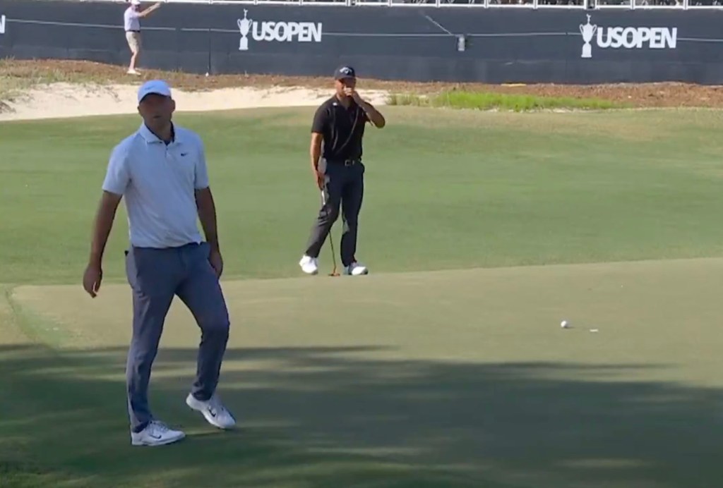 Scottie Scheffler, the top-ranked golfer, flipping his putter into the air in frustration on the greens at Pinehurst No. 2 during the U.S. Open