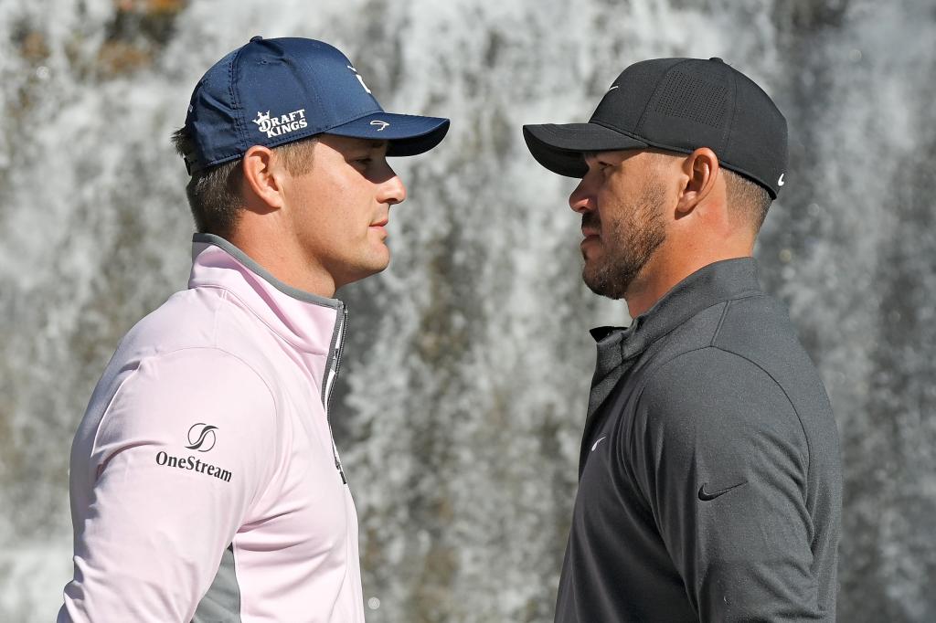 Bryson DeChambeau (L) and Brooks Koepka (R) pose for photos during Capital One's The Match V in 2021.