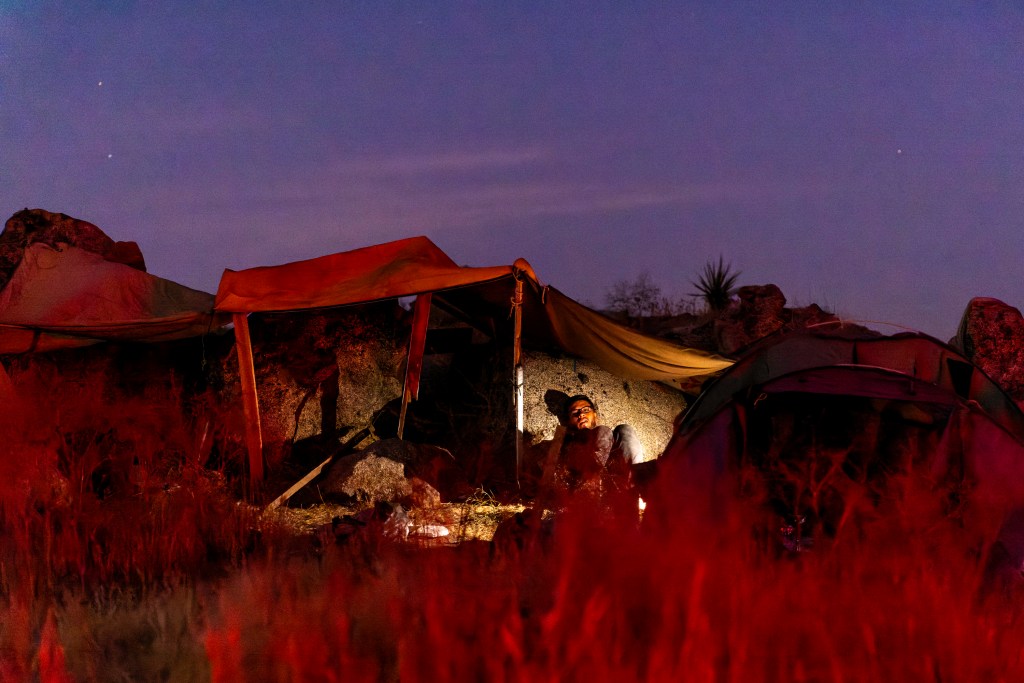 A migrant camps out in a makeshift tent in Jacumba Hot Springs, California, hoping to get picked up by Border Patrol.