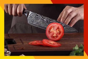A person cutting a tomato.