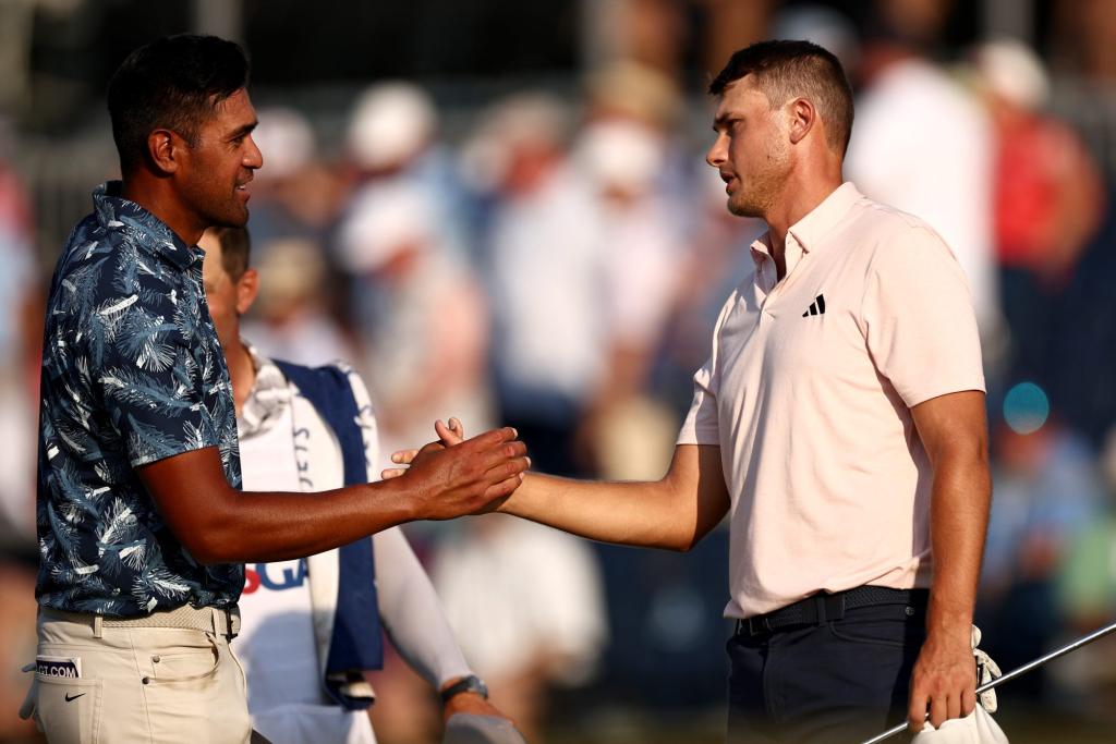 Tony Finau of the United States and Ludvig Aberg of Sweden shake hands on the 18th green during the second round of the 124th U.S. Open