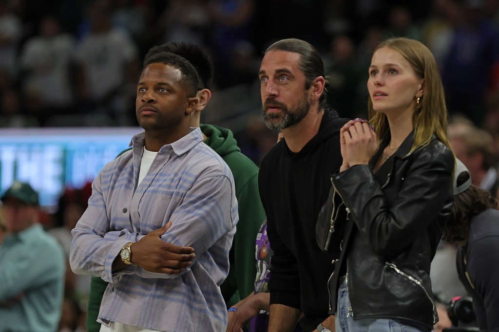 Edens (far right) was rumored to have been dating New York Jets quarterback Aaron Rodgers (seen center). Rodgers' teammate with the Green Bay Packers, Randall Cobb, is seen far left.