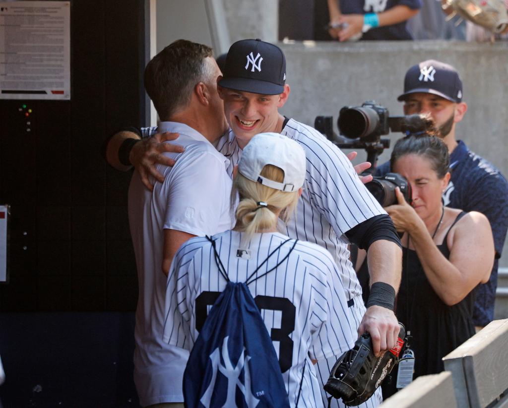 New York Yankees first baseman Ben Rice #93 hugs his father Dan Rice after the final out of the game.