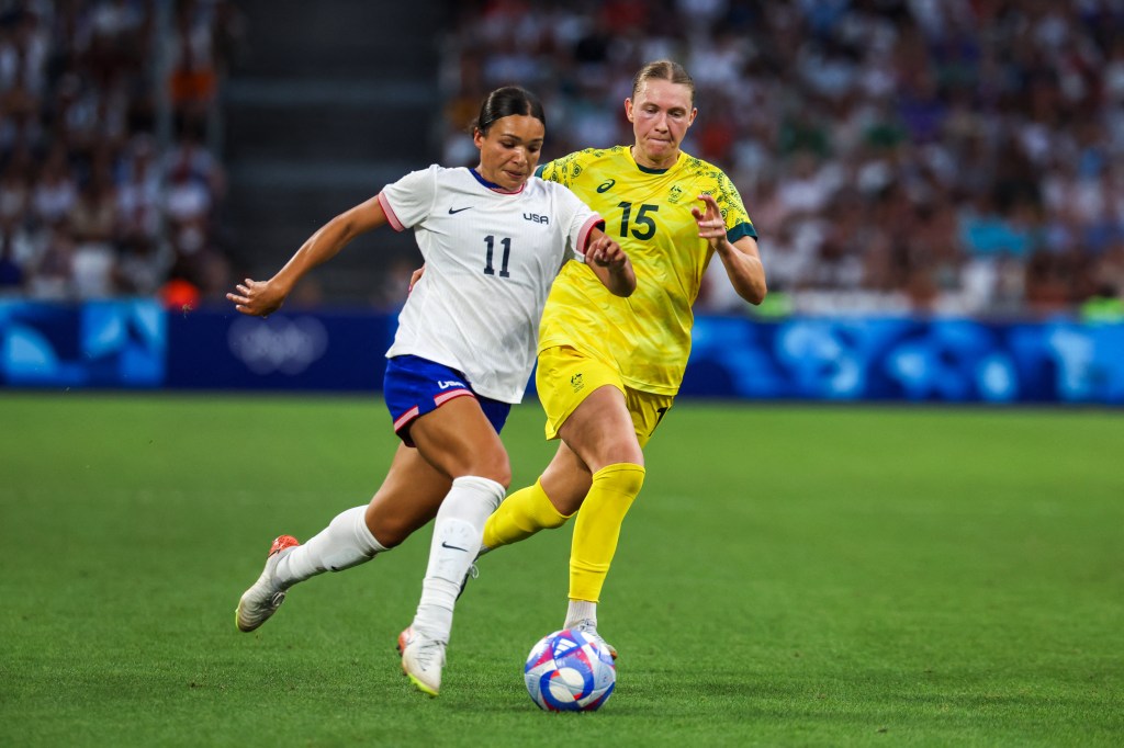 US forward #11 Sophia Smith and Australia's defender #15 Clare Hunt fights for the ball.